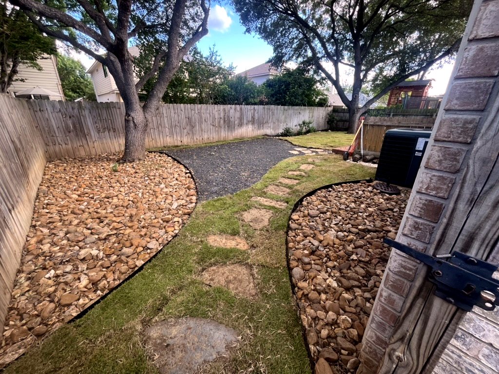 Backyard rock landscaping after Restore My Yard work